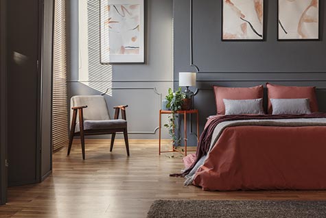 Grey painted interior residential bedroom with double bed.